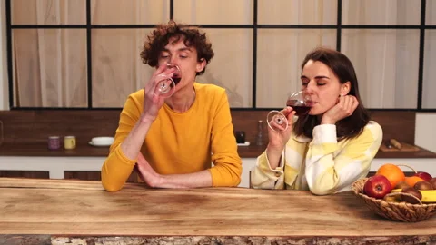 In a modern kitchen, a couple bonds over wine, enjoying each other in a cozy Stock Footage 278340939