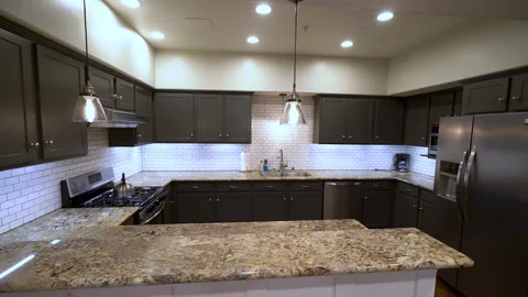 Modern kitchen with dark cabinets and granite countertop Stock Footage 345688710