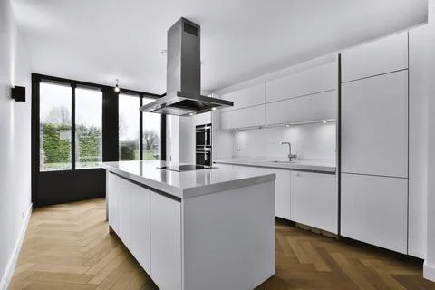 Modern kitchen design with white kitchen set and parquet floor Stock Photos