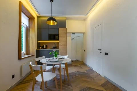 Modern kitchen with dining table and wooden flooring Stock Photos