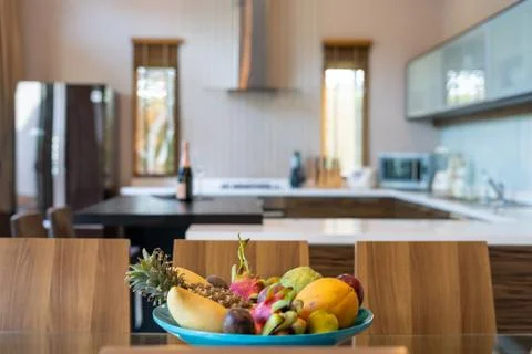 Modern kitchen feature dining table and kitchen appliance Stock Photos