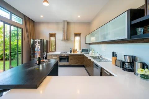 Modern kitchen feature dining table and kitchen appliance Stock Photos