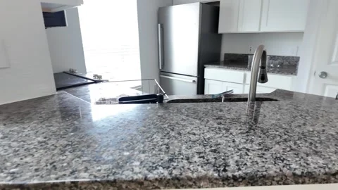Modern Kitchen Granite Countertop and Sink | Bright Open Layout Stock Footage 311207601