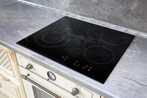 Modern kitchen interior with black induction or electric hob stove cooker wit Stock Photos