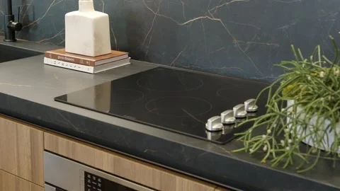 Modern kitchen interior with black marble surface, induction or electric stove Stock Footage 249685414