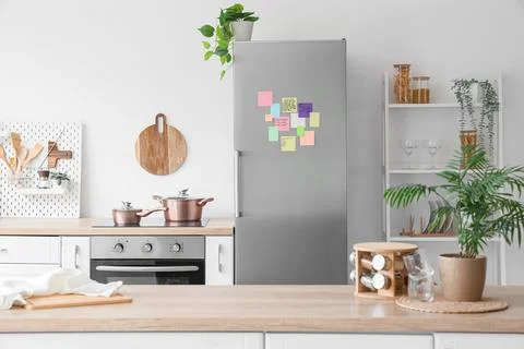 Modern kitchen interior design with stainless steel refrigerator, induction c Stock Photos