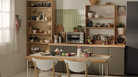 Modern Kitchen Interior Featuring Wooden Shelves with Dining Table Stock Footage 338054914