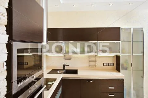 Modern kitchen interior with hardwood furniture Stock Photos