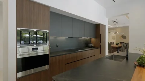 Modern kitchen interior with luxury cabinets and table top with view of garden Video stock 282274534