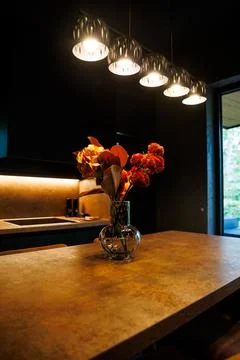 Modern Kitchen Interior with Pendant Lights and Wooden Table Stock Photos