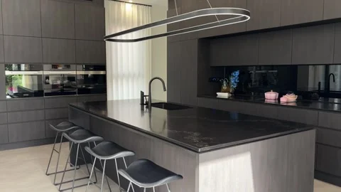 Modern Kitchen Interior Reveal with Large Island and Sculptural Pendant Lighting Stock Footage 343608181
