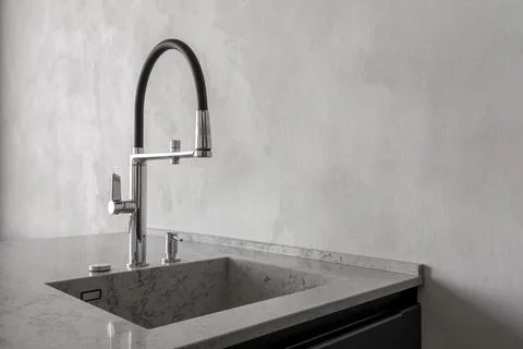 Modern kitchen interior with stone countertop, undermount sink and chrome faucet Stock Photos