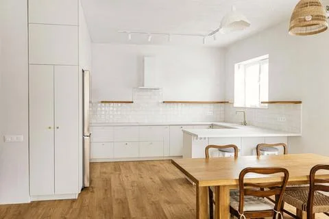Modern kitchen interior. Stylish white kitchen cabinets with brass knobs, g.. Stock Photos
