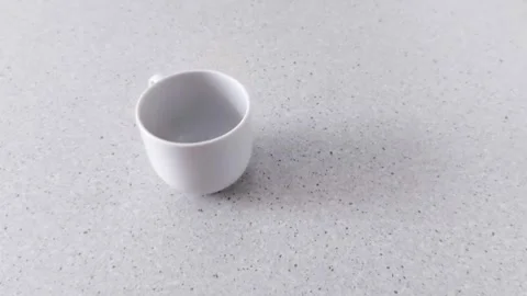 Modern Kitchen Mood: White Cup on Speckled Countertop Video stock 318641097
