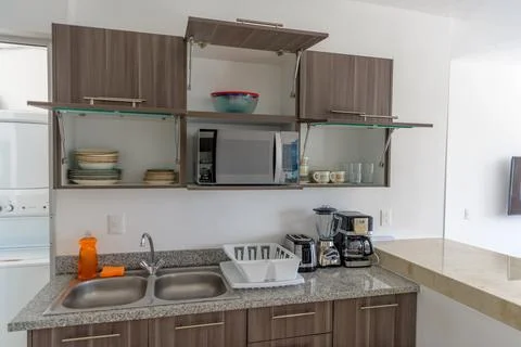 Modern kitchen with open cabinets and appliances Stock Photos