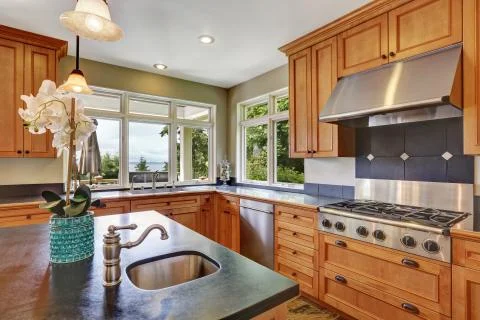 Modern kitchen room interior with new stainless steel appliances, island with Stock Photos