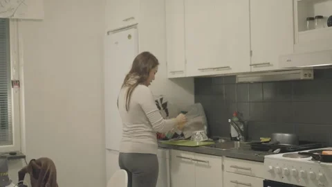 Modern Kitchen Scene with Person Engaged in Cooking Vidéo 333449360