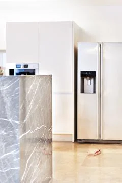 Modern kitchen tile wall with fridge and cupboard Stock Photos