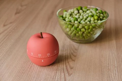 Modern kitchen timer apple shaped on the background of the kitchen Stock Photos
