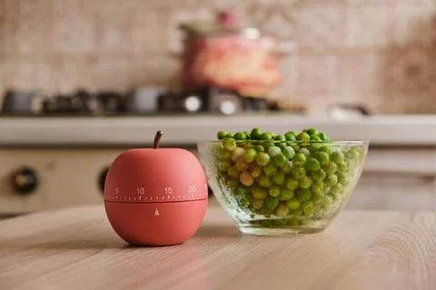 Modern kitchen timer apple shaped on the background of the kitchen Stock Photos