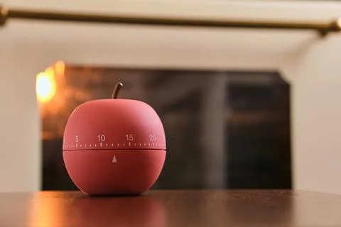 Modern kitchen timer apple shaped on the background of the kitchen Stock Photos