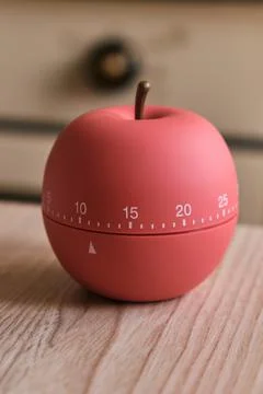 Modern kitchen timer apple shaped on the background of the kitchen Stock Photos