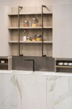 Modern kitchen white marble texture, black faucet and marble sink, hanging wo Stock Photos