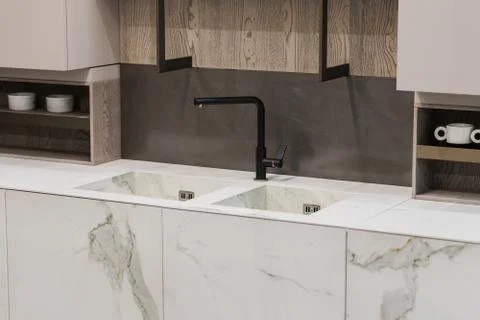 Modern kitchen white marble texture, black faucet and marble sink, hanging wo Stock Photos