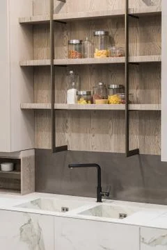 Modern kitchen white marble texture, black faucet and marble sink, hanging wo Stock Photos