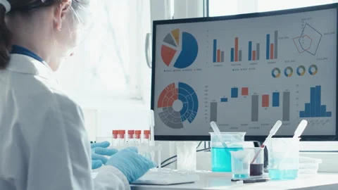 In a modern lab, a skilled scientist analyzes complex data, driving advancements Video stock 317030700