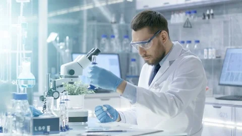 In a Modern Laboratory Scientist Conducts Experiments by Synthesising Compounds  Stock Footage 75445924