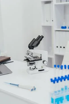 A modern laboratory setup featuring a high-powered microscope positioned on.. Stock Photos