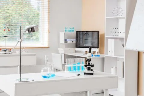 Modern laboratory workspace with microscope and test tubes Stock Photos
