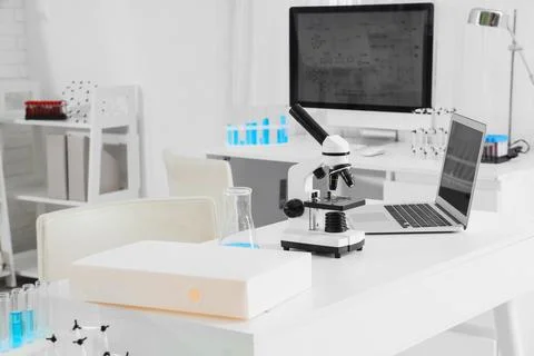 Modern laboratory workspace with microscope and computer Stock Photos