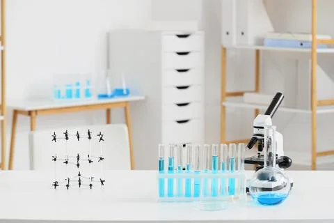 Modern laboratory workspace with microscope, test tubes, and molecular model  Stock Photos