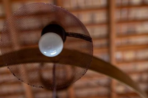 Modern lamp in foreground with antique ceiling on out of focus background. Foto stock