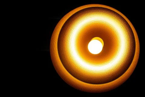 A Modern lamp hanging down from ceiling in the dark background. Minimalist ch Stock Photos