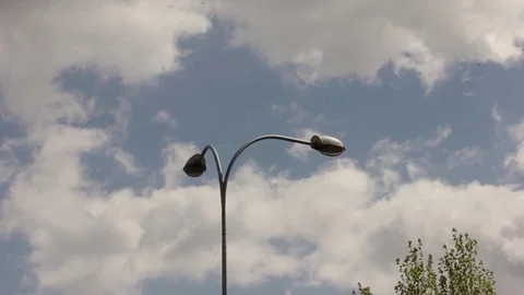 Modern lamppost is swaying in the wind on a clouds background Video stock 81583121
