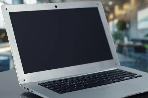 Modern Laptop with Blank Screen in a Bright Office Environment Stock Photos