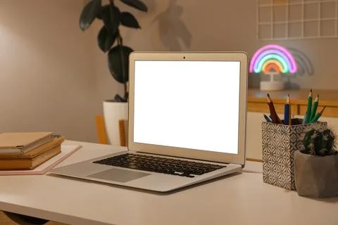 Modern laptop with blank white screen on home office desk, remote work and on Stock Photos
