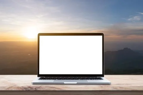 Modern Laptop computer with blank screen on wood table over mountain at sunri Stock Photos