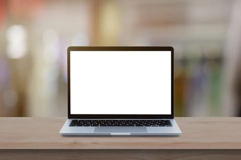 Modern Laptop computer with blank screen on wood table over blur bokeh light  Stock Photos