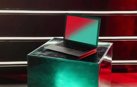 Modern laptop computer on creative designer metallic shiny cube Modern ope... Foto stock