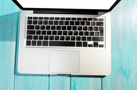 Modern laptop computer, top view Modern laptop computer on blue table, vie... Stock Photos