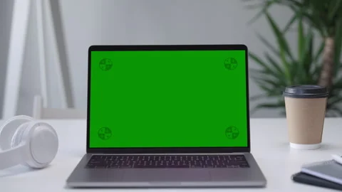Modern Laptop Computer on White Desk with Blank Empty Green Mockup Screen Stock Footage 251135455