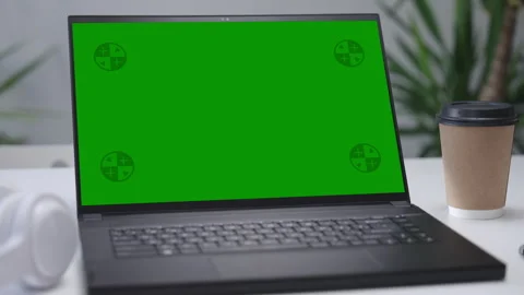 Modern Laptop Computer on White Desk with Blank Empty Green Mockup Screen Stock Footage 251525108