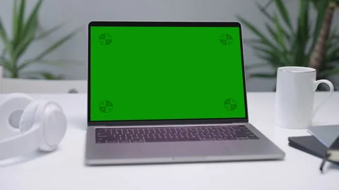 Modern Laptop Computer on White Desk with Blank Empty Green Mockup Screen Stock Footage 251525158
