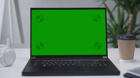 Modern Laptop Computer on White Desk with Blank Empty Green Mockup Screen Stock Footage 251731806