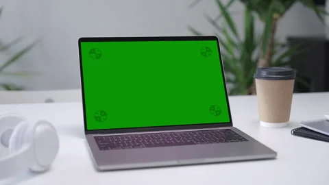 Modern Laptop Computer on White Desk with Blank Empty Green Mockup Screen Stock Footage 251946655