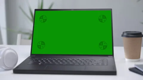 Modern Laptop Computer on White Desk with Blank Empty Green Mockup Screen Stock Footage 251946712